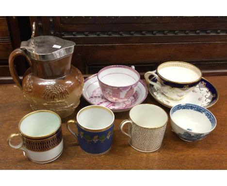 A silver mounted harvest jug together with cabinet cups and saucers. Est. £20 - £30.