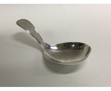 A Georgian silver caddy spoon of shaped form. London. By William Eley &amp; William Fearn. Approx. 13 grams. Est. £25 - £35.