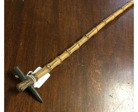 A Boer War swagger stick mounted with a bullet to end. Est. £20 - £30.