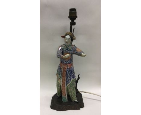 An unusual Chinese porcelain figure mounted as a lamp. Est. £30 - £50.