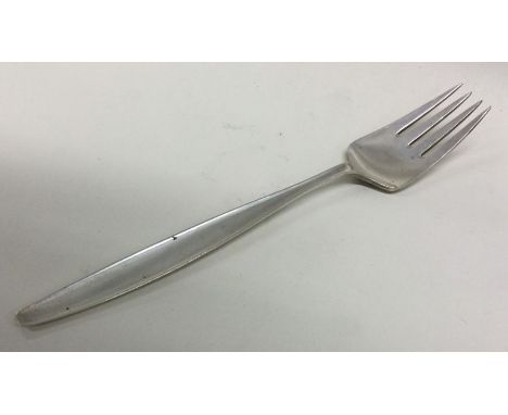 GEORG JENSEN: A silver fork of typical design. Approx. 49 grams. Est. £60 - £80.