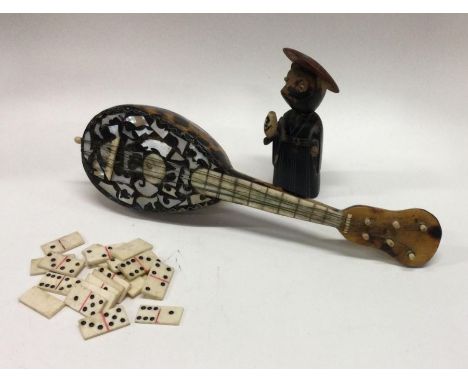 A collection of miniature bone dominoes together with a model figure etc. Est. £20 - £30.