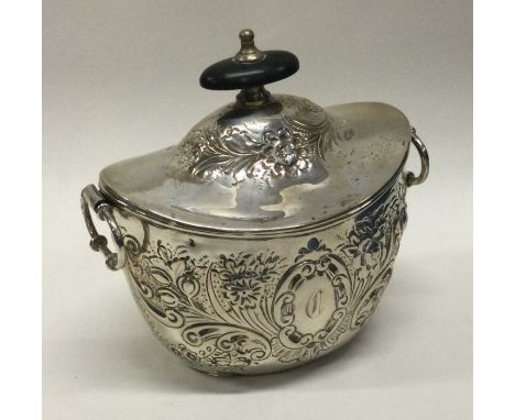 A chased silver boat shaped tea caddy. Approx. 137 grams. Est. £30 - £40.