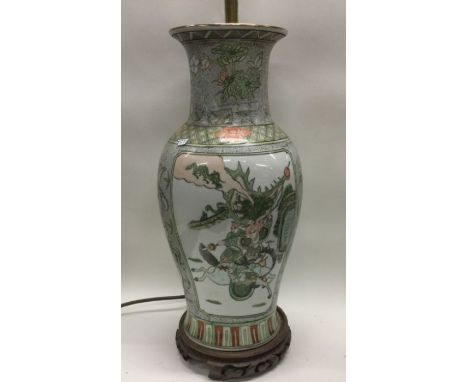 A large Chinese lamp decorated with warriors. Est. £30 - £50.