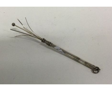A silver swizzle stick with loop top. Approx. 7 grams. Est. £20 - £30.