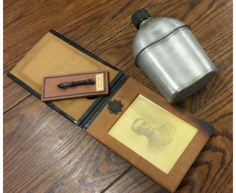 An American army issue water bottle together with an arrow head mounted on board etc. Est. £20 - £30.