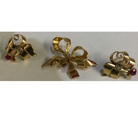 An attractive 18 carat gold French ruby and diamond brooch together with matching earrings. Approx. 12 grams. Est. £450 - £55