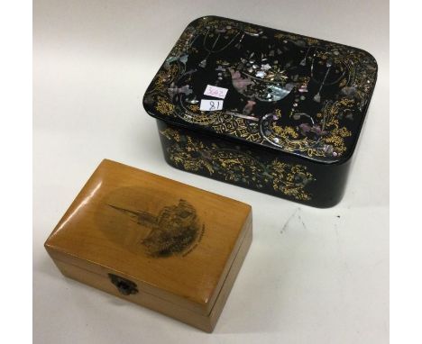 A papier-mâché snuff box together with one other. Est. £30 - £40.