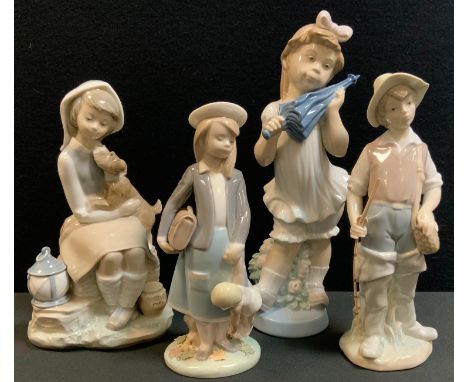 A Lladro figure of a seated girl playing with a dog, a lantern at her side, 21.5cm high;  others Girl with parasol, fisher bo
