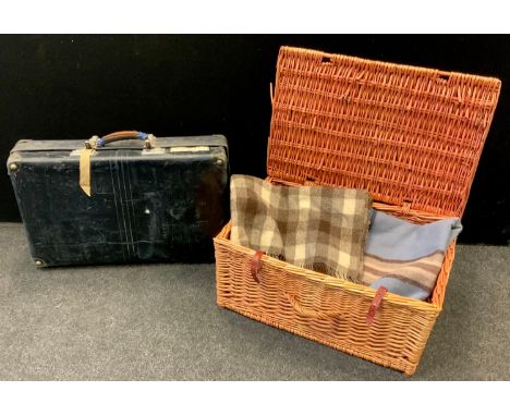 A larger wicker hamper containing blankets; a vintage suitcase etc. 