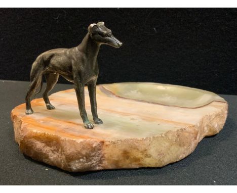 A 20th century cast metal and onyx trinket dish, natural banded green onyx base mounted with a cast metal model of a standing