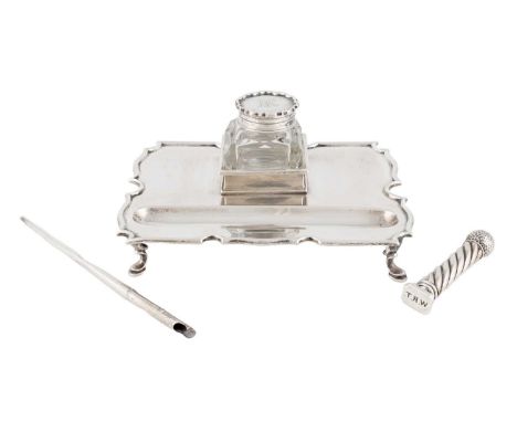 A late-Victorian silver inkwell, by Gibson and Langman, London 1898, shaped rectangular form, moulded border, with a silver-m