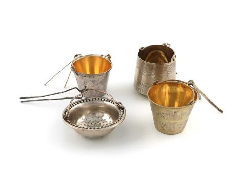 A collection of four Russian silver and silver-gilt spout hanging tea strainers, comprising: three of bucket form, one with e