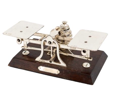 A silver pair of letter scales,by George Betjemann &amp; Sons, London 1915, retailed by Asprey,rectangular platforms on a sca