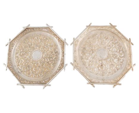 A pair of metalware waiters,stamped K.S.W, possibly Indian, octagonal form with bamboo borders, scroll foliate decoration on 