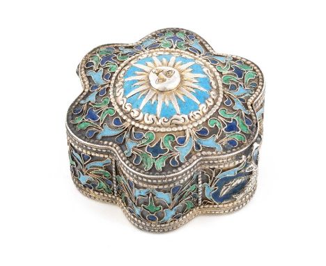 An Armenian metalware and enamel box,unmarked,circular form, with two-colour blue and green enamel decoration on a matted bac