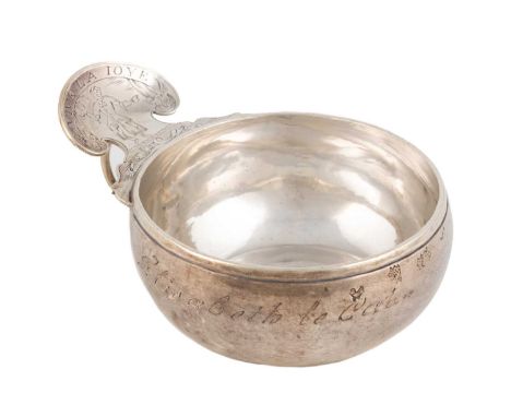 A Louis XVI French provincial silver wine taster, by Mathieu Lamoureux, Rouen 1779, circular form, the shaped scroll thumb-pi