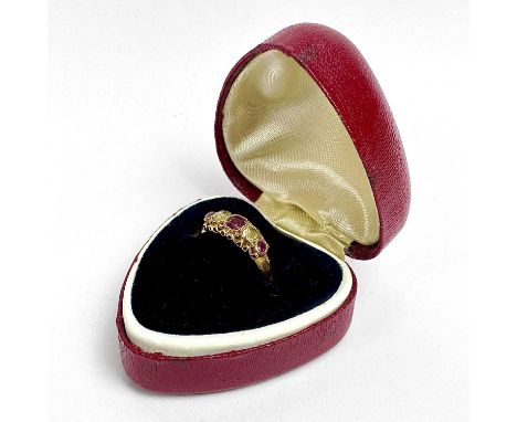 A Victorian 15ct garnet and yellow stone five stone ring, the cushion shaped stones in a scroll mount, partial hallmark, size