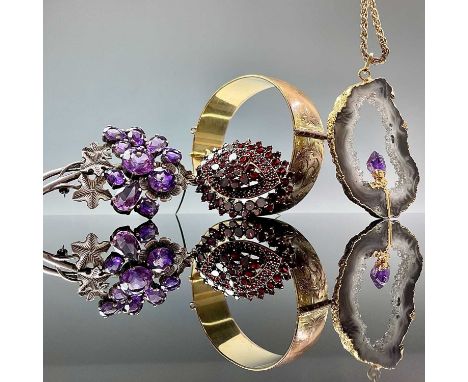 A 1960's silver and amethyst floral brooch, maker T.M &amp; CO, Birmingham 1964, length 70mm; together with a gold plated aga