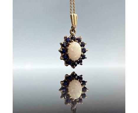 A 9ct opal and sapphire cluster pendant necklace, the oval white opal measures 0.10ct approximately, weight 2.82g.Condition r