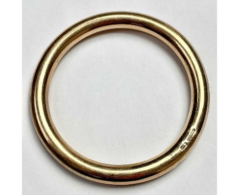 A 9ct hallmarked gold hollow tubular bangle, inner diameter 68mm, weight 21.77g.Condition report: Good used condition. One de