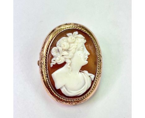 A 9ct gold mounted oval shell cameo brooch, the cameo with profile bust portrait of a lady, 30 x 22mm, weight 4.53g.