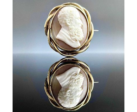 A Victorian gold mounted shell cameo oval brooch, the cameo carved with a profile bust portrait of Michelangelo, the back wit