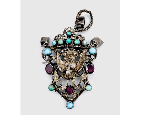 An Austro Hungarian silver gilt turquoise and garnet set brooch, of architectural scroll form and cast with a stork attending