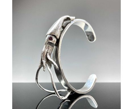 A good contemporary heavy fine .999 silver bangle, applied with and named Newlyn Squid with ruby cabochon set eyes, weight 10