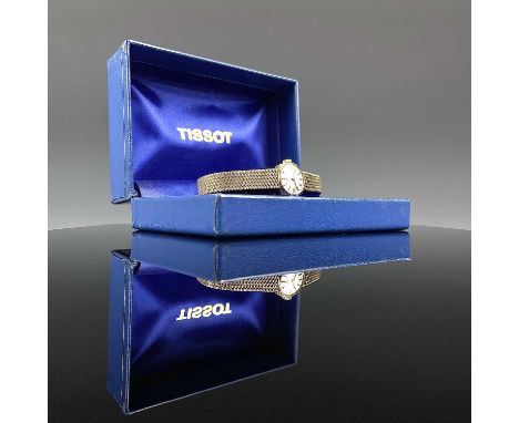 A Tissot 9ct gold ladies manual wind bracelet wristwatch, the silver 14mm dial with baton markers, the 17 jewel movement sign