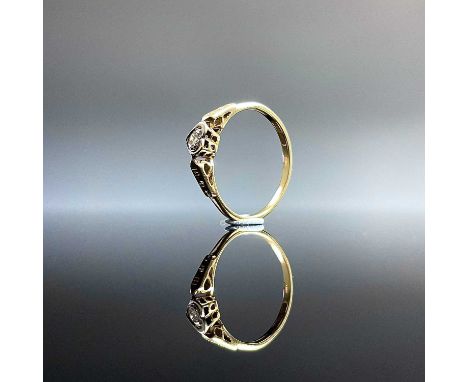 An 18ct gold and platinum diamond set solitaire ring, the 0.07ct diamond in a platinum heart shaped collet setting, size L/M,