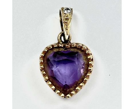 A gold and amethyst heart shaped pendant, the suspension loop set a small diamond, length including loop 20mm, weight 1.08g.