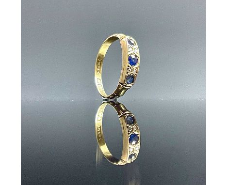 An Edwardian 18ct gold diamond and sapphire seven stone ring, the largest sapphire measure 0.07ct, Birmingham 1906, size J/K,