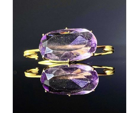 A high purity gold amethyst set brooch, the oval cut stone measuring 24 x 19mm, weight 6.43g.