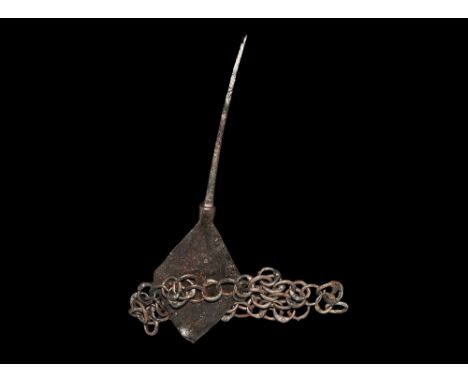  10th-12th century AD. A broad lozengiform iron arrowhead with bolster and long tapering tang penetrating a section of iron m