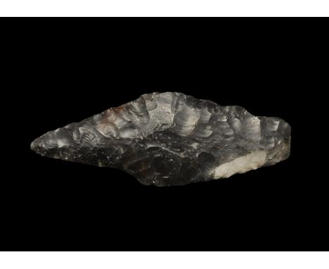  Neolithic, 3rd millennium BC. A finely knapped triangular bifacial spearhead with square tang, in dark grey flint. 25 grams,