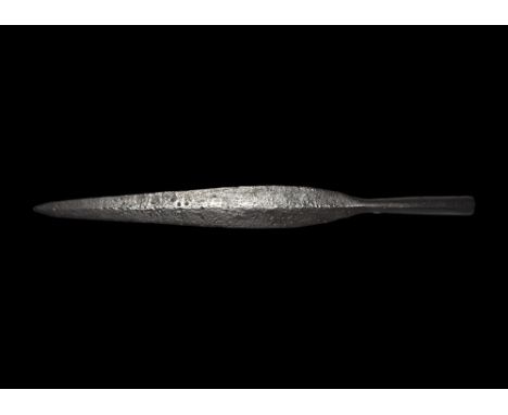 9th-11th century AD. A hand-forged iron spearhead with lozenge-section leaf-shaped blade, short neck, long closed socket wit