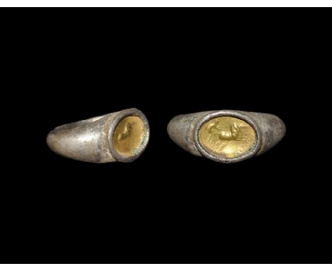  3rd century AD. A D-section silver hoop with keeled expanding shoulders, with later flat plaque with discoid cell and gold i
