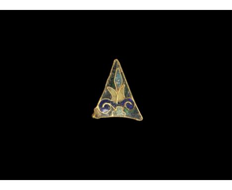  11th-12th century AD. A triangular panel ornamented with a fleur-de-lis motif in cloisonné blue, white and green enamel. 0.7