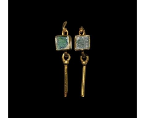  2nd-3rd century AD. A matched pair of gold earrings, each a wire hoop with hook-and-eye closure, applied square cell with gr