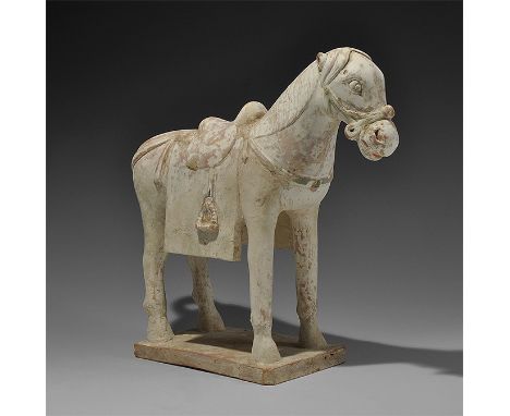  Ming Dynasty, 1368-1644 AD. A ceramic figurine of a standing pony on a rectangular base with bridle and harness, stirrups, s