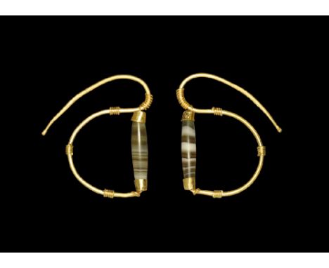  6th-4th century BC. A matched pair of gold earrings, each a tapering rod with S-curved profile, granule finial, four bands o
