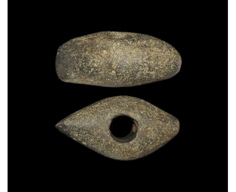  Neolithic, 4th-2nd millennium BC. A pecked and polished stone perforated axe-hammer with boat-shaped profile. 712 grams, 13.