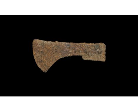  10th-14th century AD. A hand-forged iron axehead with D-section socket, tapering blade with flared edge and scooped lower ed