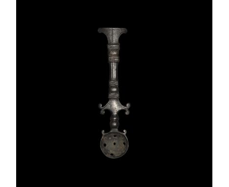  1st-2nd century AD. A bronze cosmetic or culinary strainer with square-section balustered shank and ribbed collars, T-shaped