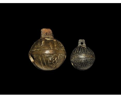  17th-18th century AD. A mixed pair of crotal bells each with a pierced flange for suspension, two holes in the upper face an