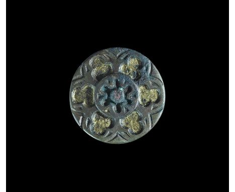  14th-15th century AD. A discoid plaque with central hub, disc with six radiating enamel-filled petals with wedges between, o