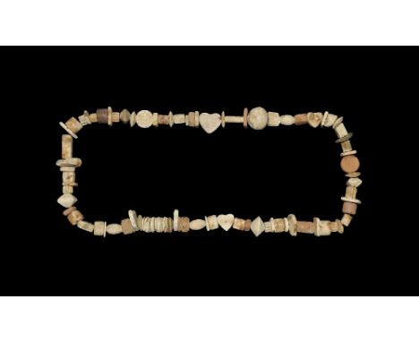  1st millennium BC and later. A strand of ceramic unglazed beads comprising ovoid, rectangular, fluted, bi-conical, cylindric