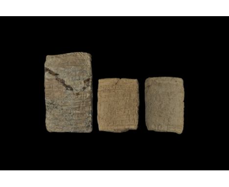  20th-16th century BC. A group of ceramic pillow-shaped cuneiform tablets with sparse text. 281 grams total, 55-86mm (2 1/4 -