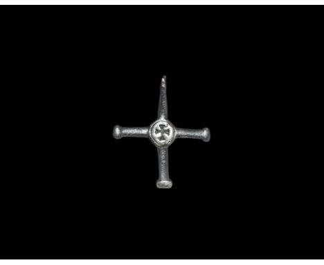  9th-10th century AD. A silver cruciform pendant with four short arms, each with a knop finial; central circular plaque with 